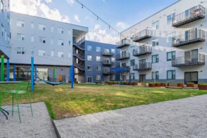 Modern apartment courtyard with greenery.
