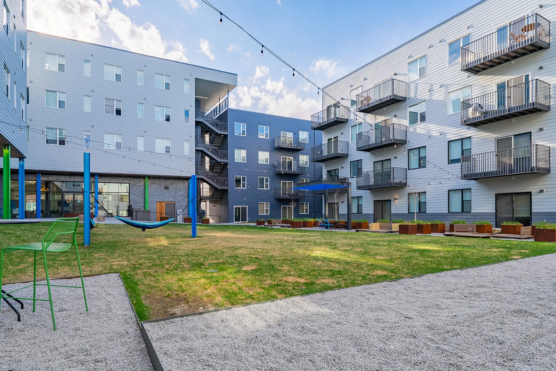 Modern apartment courtyard with greenery.